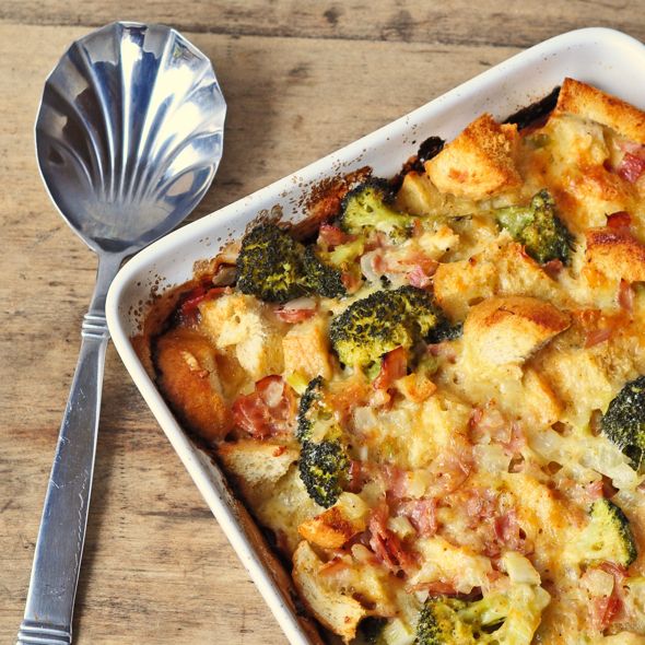 Breakfast Casserole with Broccoli, Ham and Cheese in a baking dish on a table with a sliver serving spoon