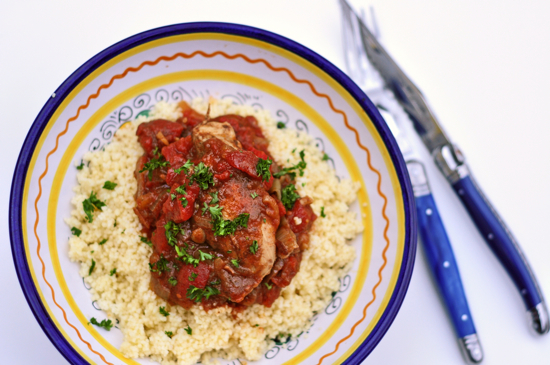 Moroccan chicken with tomatoes and honey in a bowl on couscous