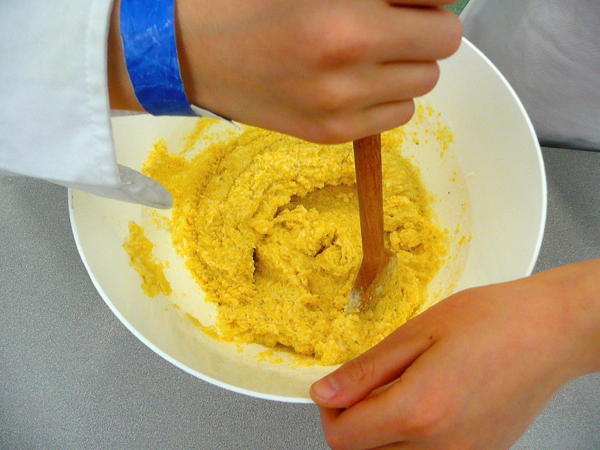 Kids mixing tamale filling with Rossy Earle by eatlivetravelwrite.com
