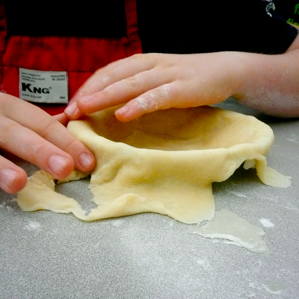 Kids working with pie crust Mardi Michels eatlivetravelwrite.com