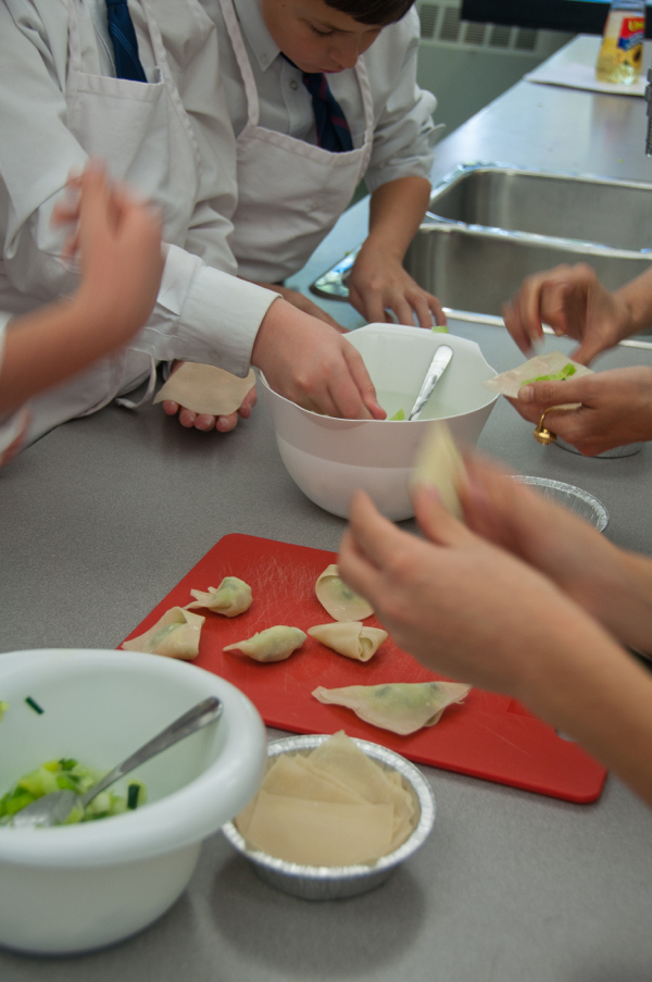 Kids filling dumplings on eatlivetravelwrite.com