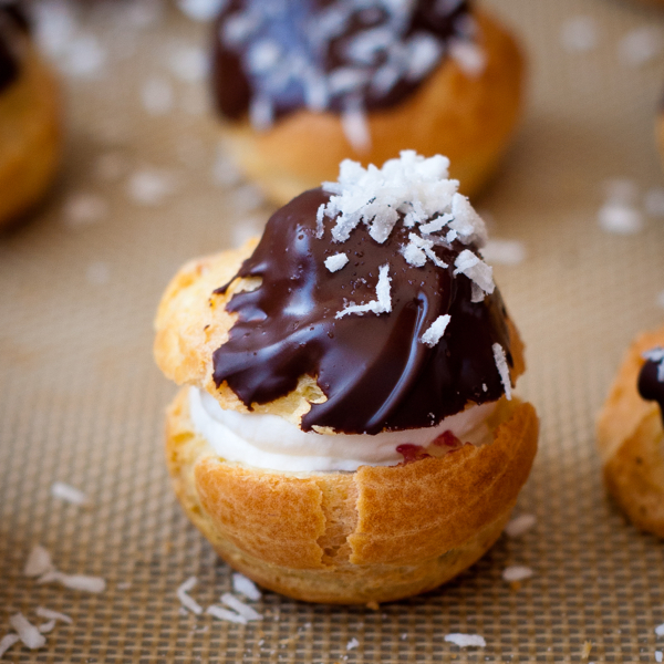Choux puffs filled with jam and cream and topped with chocolate on eatlivetravelwrite.com