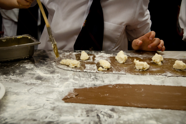 Kids putting mascarpone filling in chocolate ravioli on eatlivetravelwrite.com