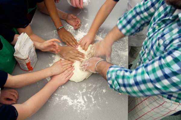Kids feeling pizza dough on eatlivetravelwrite.com