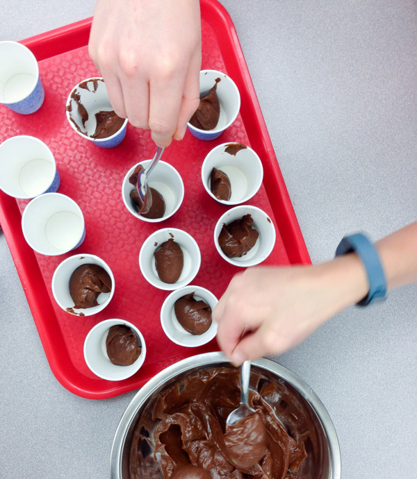 Kids making chocolate avocado pudding on eatlivetravelwrite.com