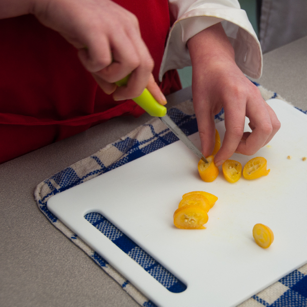 Kids chopping kumquats for jam on eatlivetravelwrite.com