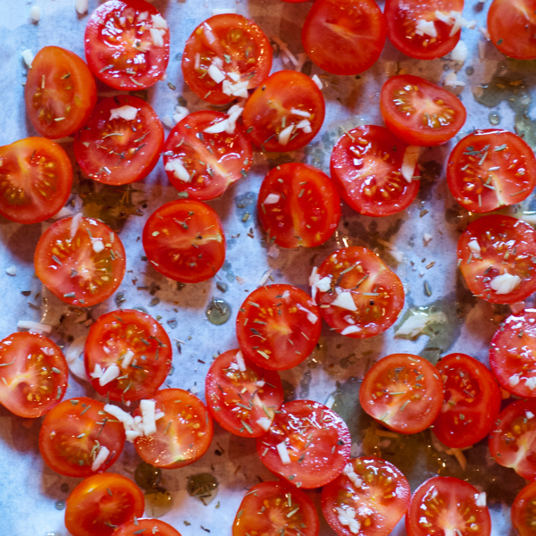 Prepping cherry tomatoes to slow roast on eatlivetravelwrite.com