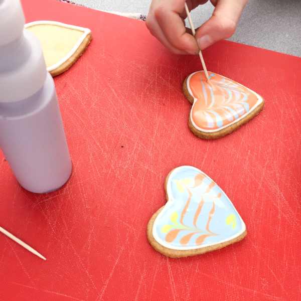 Using toothpicks to drag icing over on cookies on eatlivetravelwrite.com