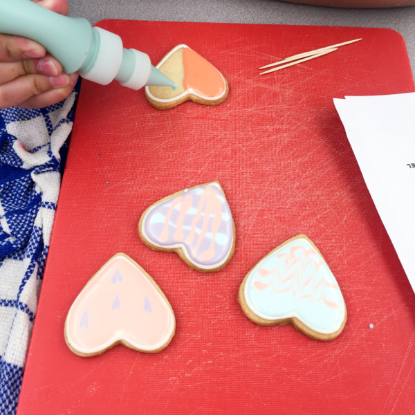 Kids decorating cookies for Valentine's Day on eatlivetravelwrite.com