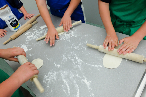 Kids rolling pizza dough on eatlivetravelwrite.com