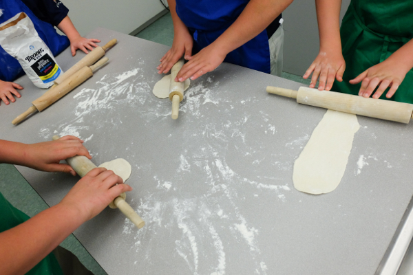 Kids rolling Jamie Oliver pizza dough on eatlivetravelwrite.com
