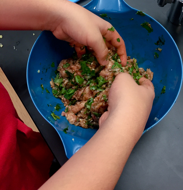 Mixing dumpling filling with our bare hands √