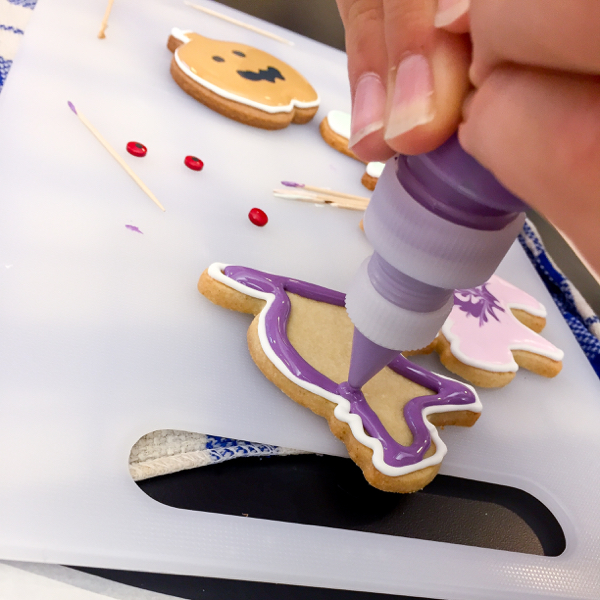 Kids decorating cookies for Halloween on eatlivetravelwrite.com