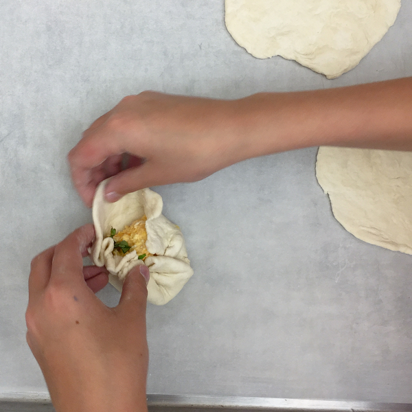 Kids filling Georgian cheese breads on eatlivetravelwrite.com