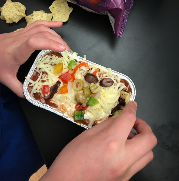 Kids digging into Joanne Lusted Layered Nacho Dip on eatlivetravelwrite.com