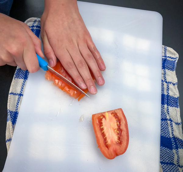 Kids chop and seed tomatoes to make Persian watermelon salad on eatlivetravelwrite.com