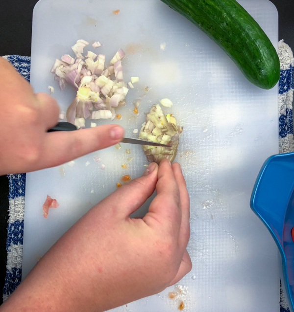 Kids chop shallots to make Persian watermelon salad on eatlivetravelwrite.com