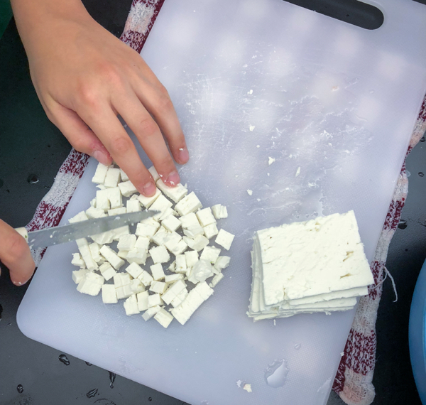 Kids dicing feta to make Persian watermelon salad on eatlivetravelwrite.com