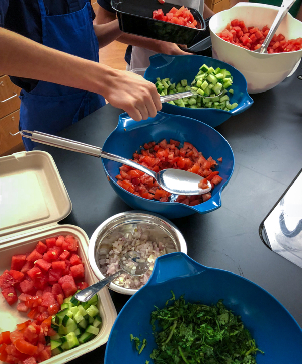 Kids assembling Persian watermelon salad on eatlivetravelwrite.com