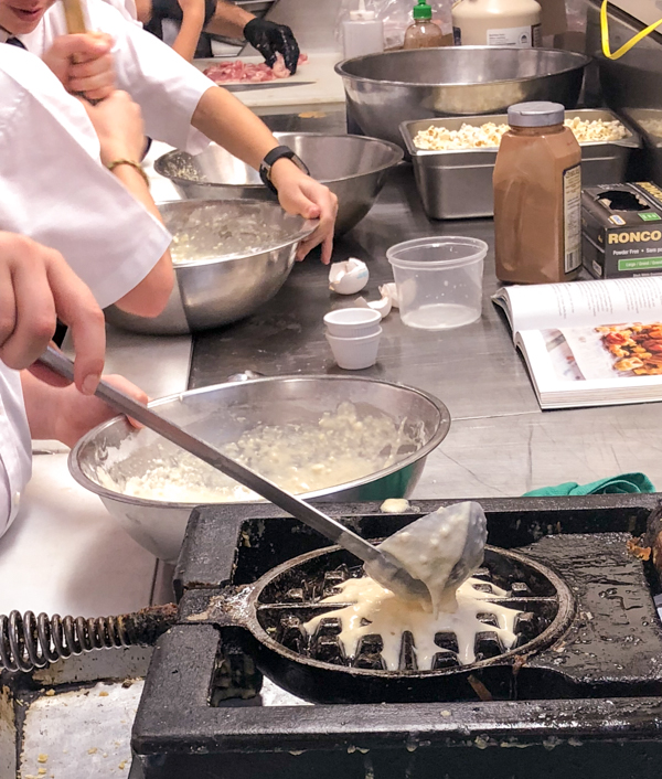 Ladling waffle batter from Brunch Life at Lisa Marie with Matt Basile on eatlivetravelwrite.com