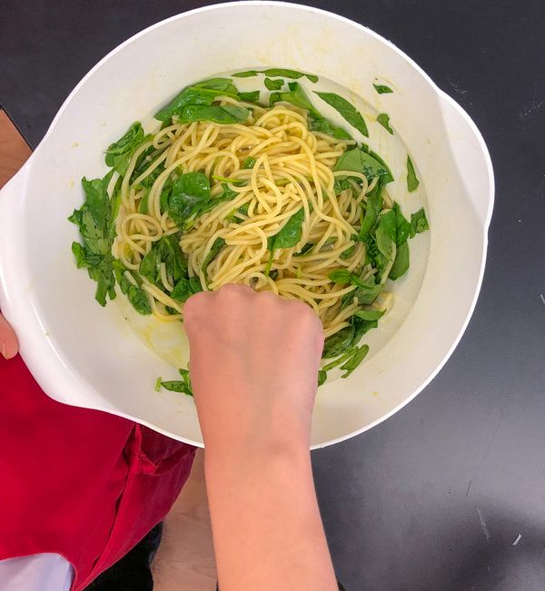 Whisking ingredients for Bacon spinach and spaghetti frittata from Weekday Suppers by Emily Richards on eatlivetravelwrite.com