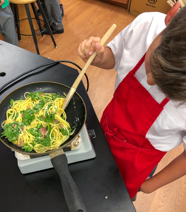 Checking to see if its done making Bacon spinach and spaghetti frittata from Weekday Suppers by Emily Richards on eatlivetravelwrite.com