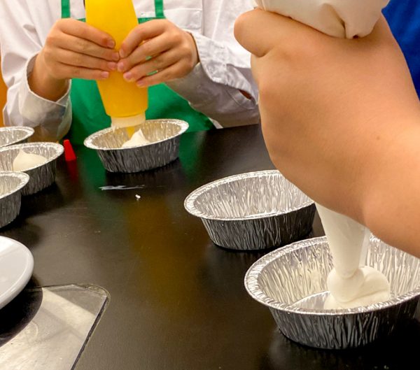 Kids using piping bags and squeeze bottles with John Placko on eatlivetravelwrite.com