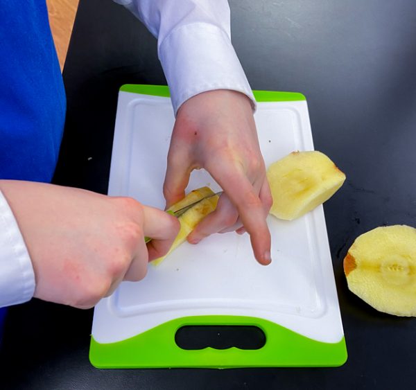 Kids slicing apples to make Apple Pie Waffles from Brunch Life with Matt Basile on eatlivetravelwrite.com