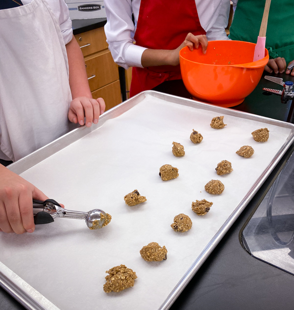 Careful measuring making cookies from Peace, Love and Fibre by Mairlyn Smith on eatlivetravelwrite.com