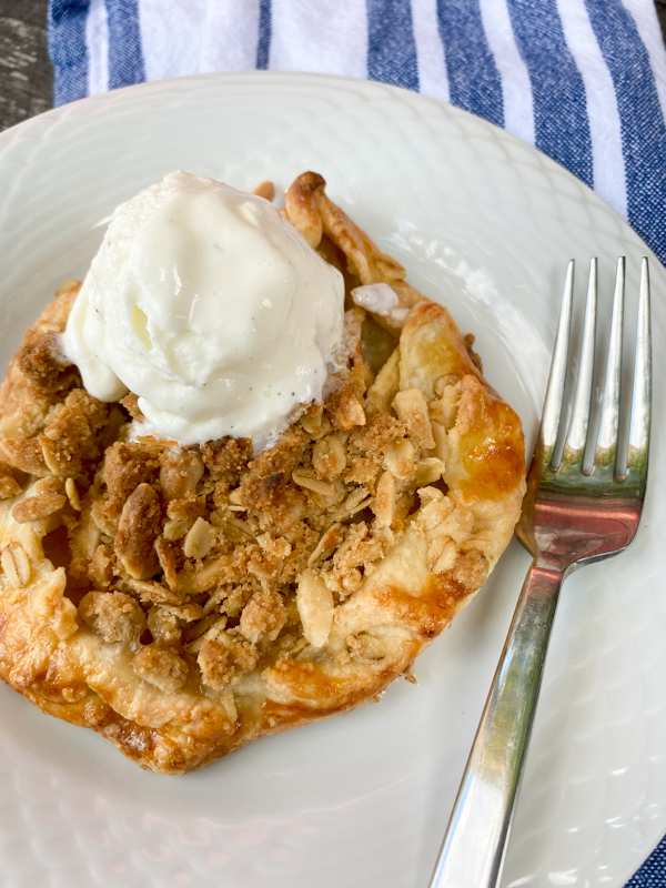 Apple crumble galette with ice cream on a plate