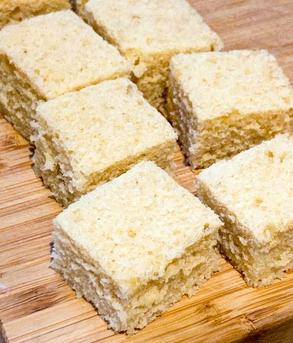 Cubes of pound cake on a cutting board.