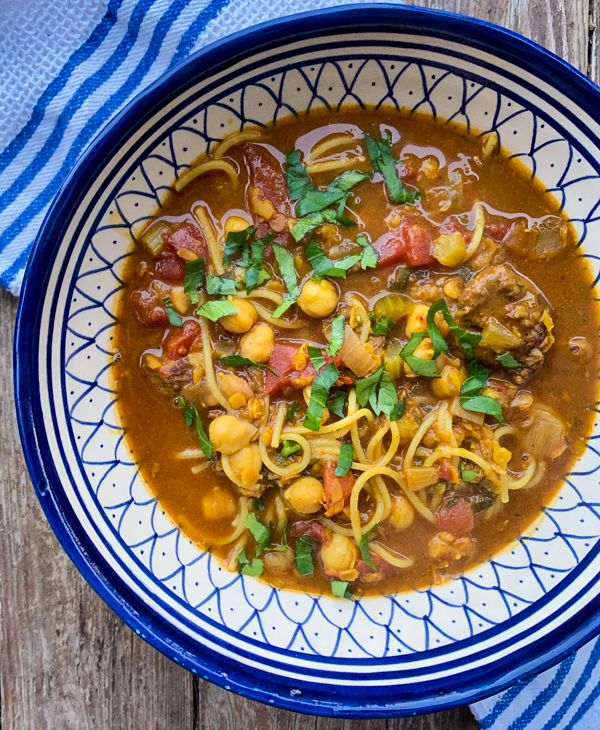 Moroccan spiced chickpea and noodle soup from Everyday Dorie in a blue and white bowl.