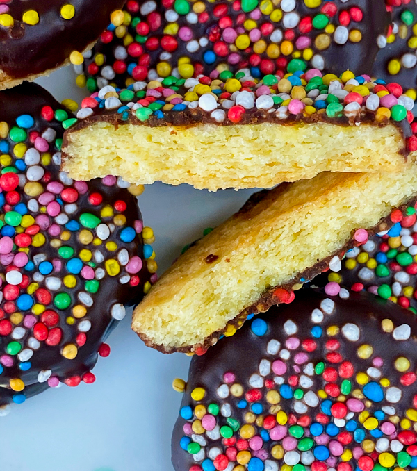Flaky shortbread cookies with chocolate topping and sprinkles.