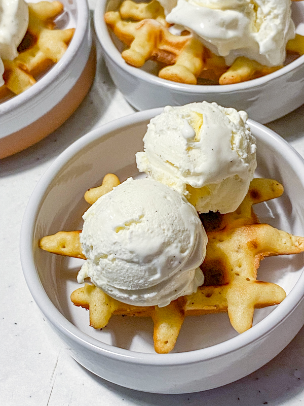 Mini waffles topped with ice cream.