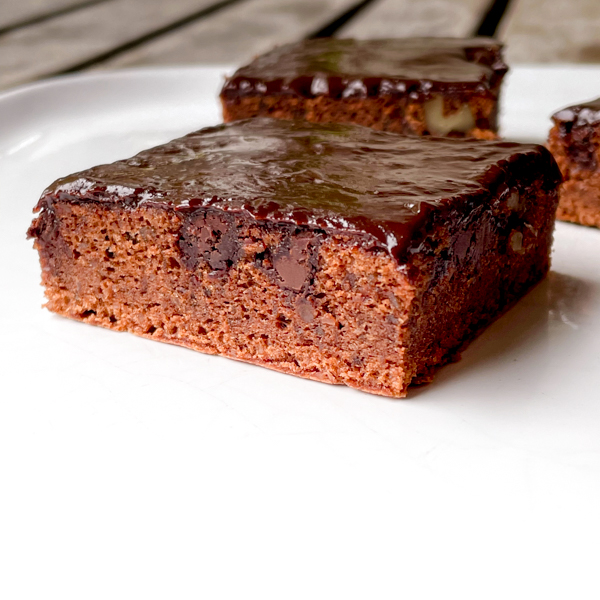 Cross section of Chocolate and Walnut Bars on a white plate.