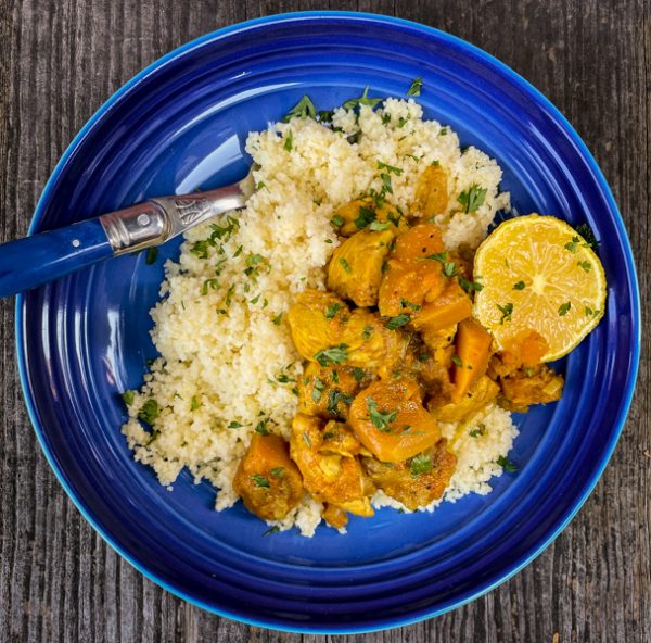 Dorie Greenspan's Chicken and winter squash tagine on a blue plate.