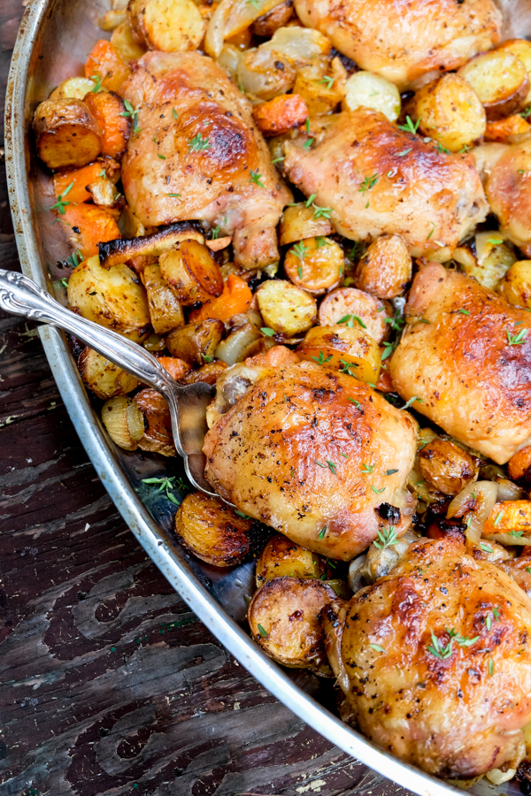 Roast chicken dinner in a pan.