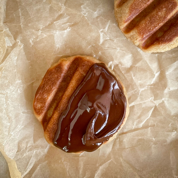 Close up image of a chocolate-dipped wafflet.
