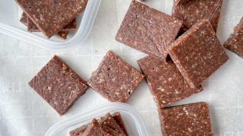 No-bake chocolate hazelnut energy squares on a baking tray lined with parchment.