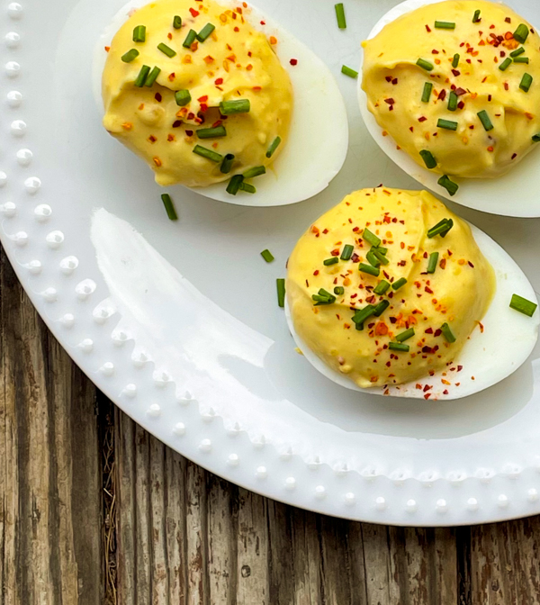 Double-Stuffed Deviled Eggs with Crab on a white plate.
