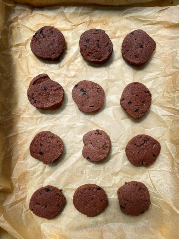 Chocolate olive cookies from Dorie Greenspan's Dorie's Cookies on a parchment-lined baking tray.