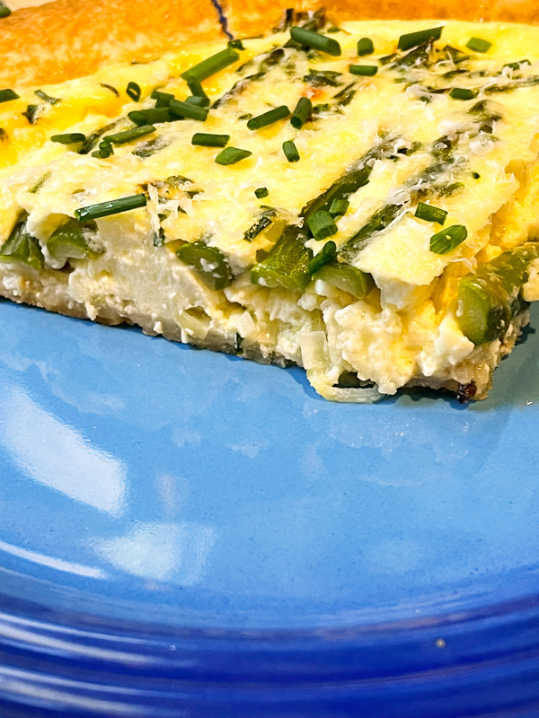 A cut slice of Asparagus-Lemon Quiche from Baking with Dorie.
