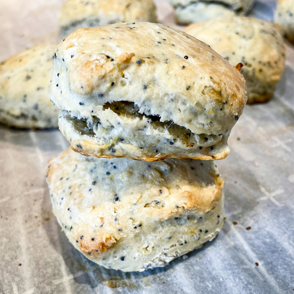 Lemon poppyseed scones on a baking tray lined with parchment paper.
