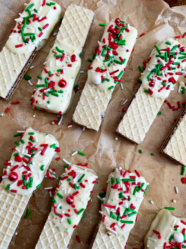 White chocolate Dipped wafer cookies on a parchment paper-lined tray.