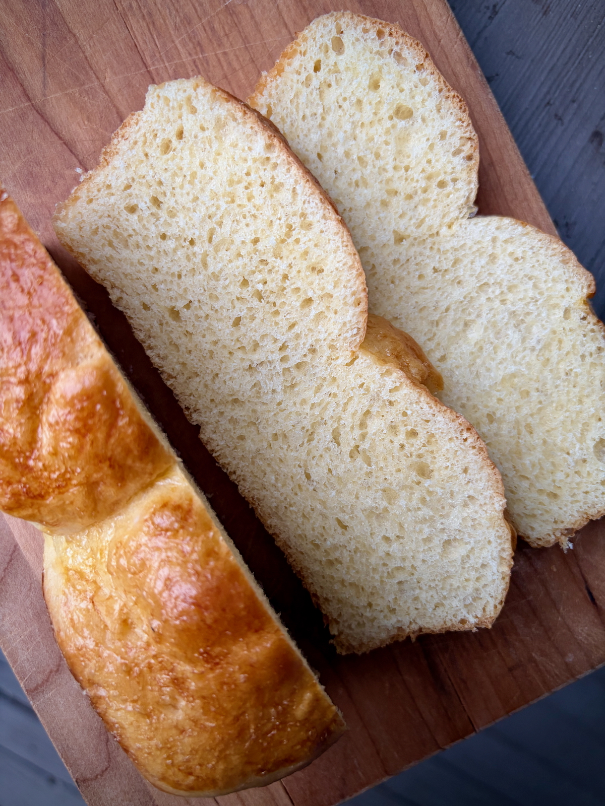Two slices of brioche on a cutting board.