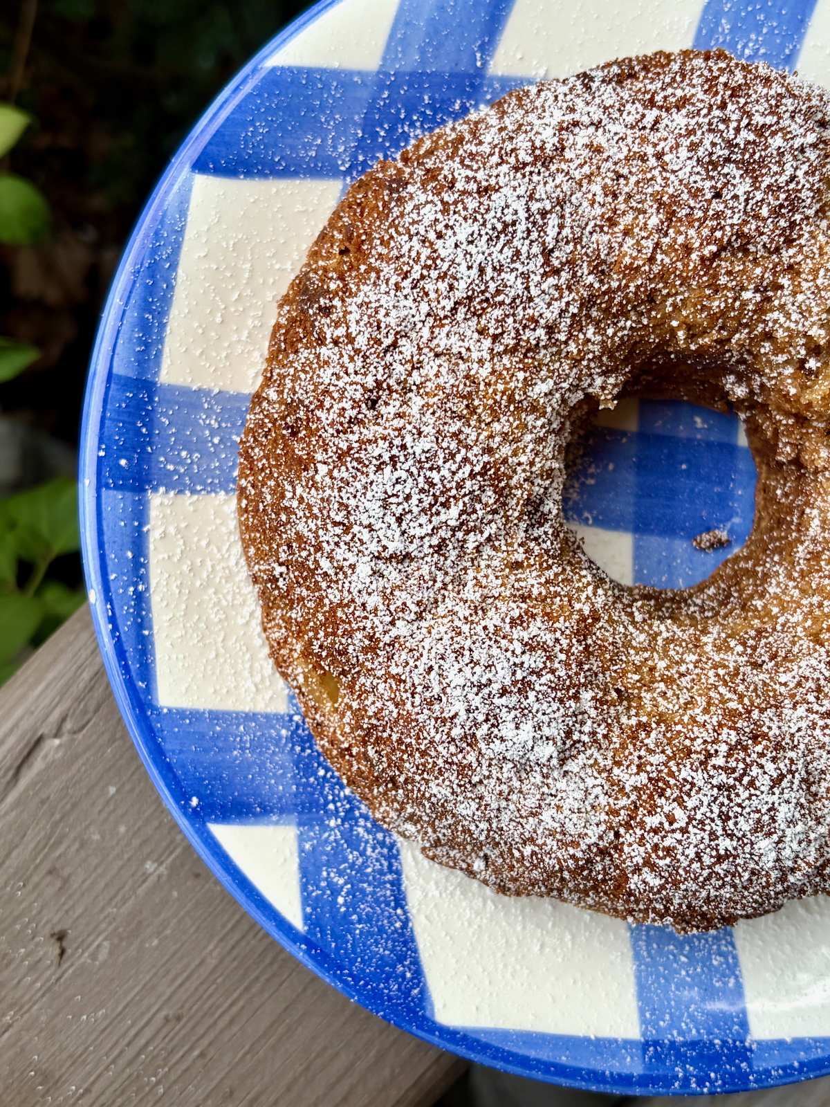 Overhead view of Dorie Greenspan's First-of-Fall Apple Bundt Cake on a blue and white plate.