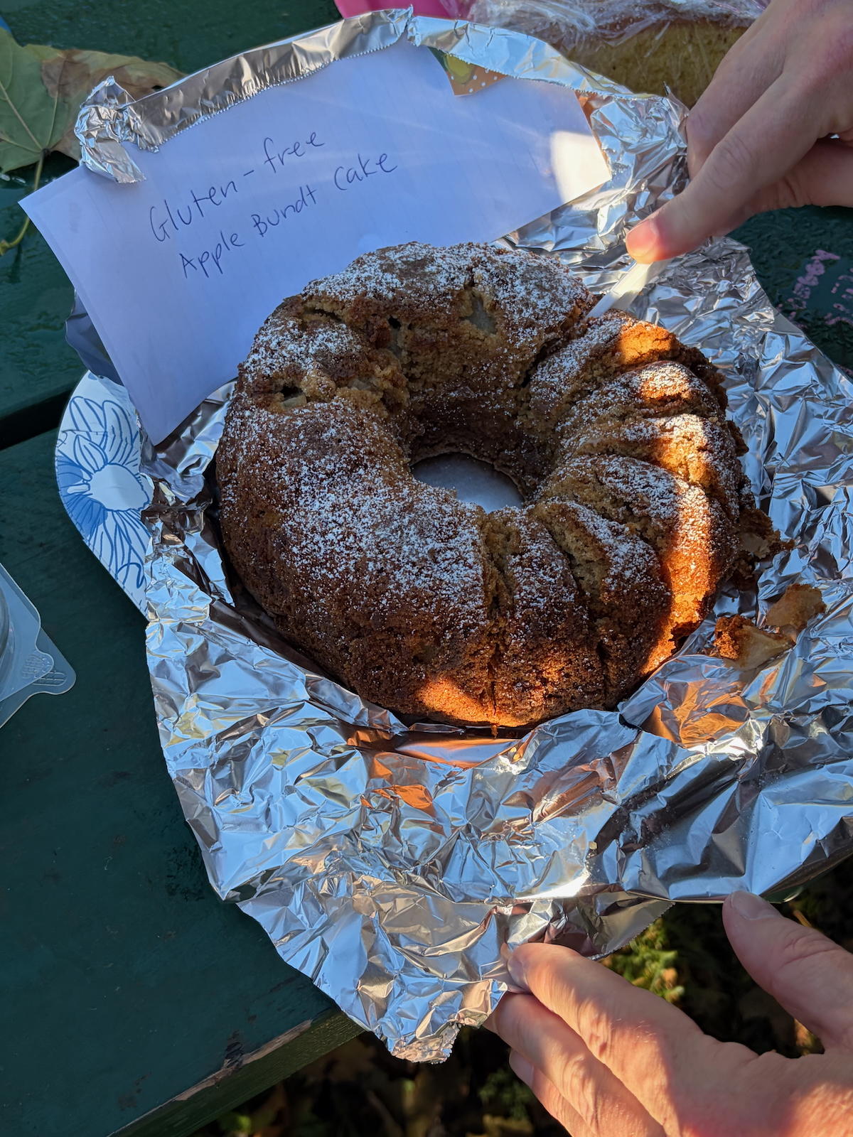 Someone slicing Dorie Greenspan's First-of-Fall Apple Bundt Cake.